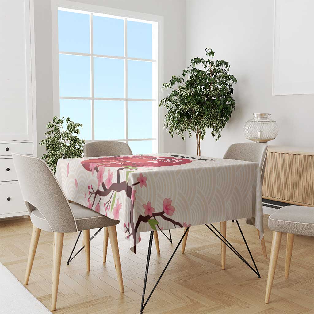 White tablecloth with pink cherry blossoms and branch pattern on a dining set