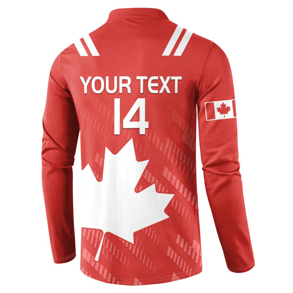Red rugby button sweatshirt, white Canada maple leaf graphic, sleeve patch, striped shoulders.