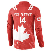 Red rugby button sweatshirt, white Canada maple leaf graphic, sleeve patch, striped shoulders.