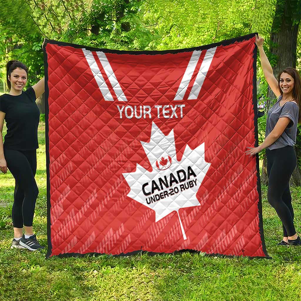 Red quilt spread outdoors with white maple leaf and “CANADA UNDER-20 RUBY” logo