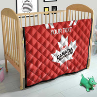 Red quilt on crib with white maple leaf and “CANADA UNDER-20 RUBY” logo