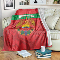 Red and green flag-style throw blanket with Transnistria emblem, draped over couch