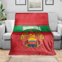 Red and green flag throw blanket with Transnistria emblem, laid across a sofa