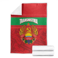 Folded red and green flag-style throw blanket with Transnistria emblem, with rolled towels