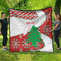 Red and white quilt laid outdoors, featuring Lebanon map, tree, and decorative medallions