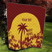 Folded maroon and yellow quilt with palm tree emblem, “WEST INDIES” text, and “YOUR TEXT”