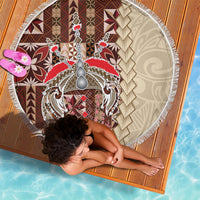 Round beach blanket, top view: white-fringed edge with brown, red, and cream siapo design