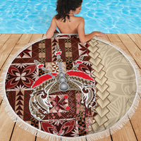Round beach blanket with white fringe and central siapo emblem in brown, red, and cream