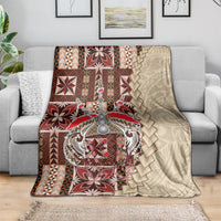 Samoan tapau siapo-pattern blanket draped on couch, brown and tan with burgundy motifs