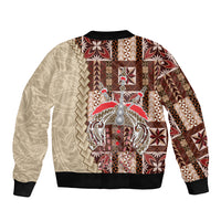 Bomber jacket with cream-and-brown geometric print, large central crest, black ribbed cuffs and hem