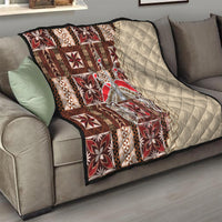 Quilt draped on sofa: brown and red patchwork motifs over cream diamond-quilted reverse.