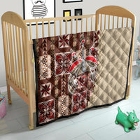 Baby quilt with brown, red, and cream geometric tapa-inspired blocks and cream quilted back.