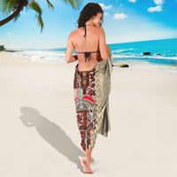 Brown and cream sarong tied at the back; cream swirl pattern with red geometric panel