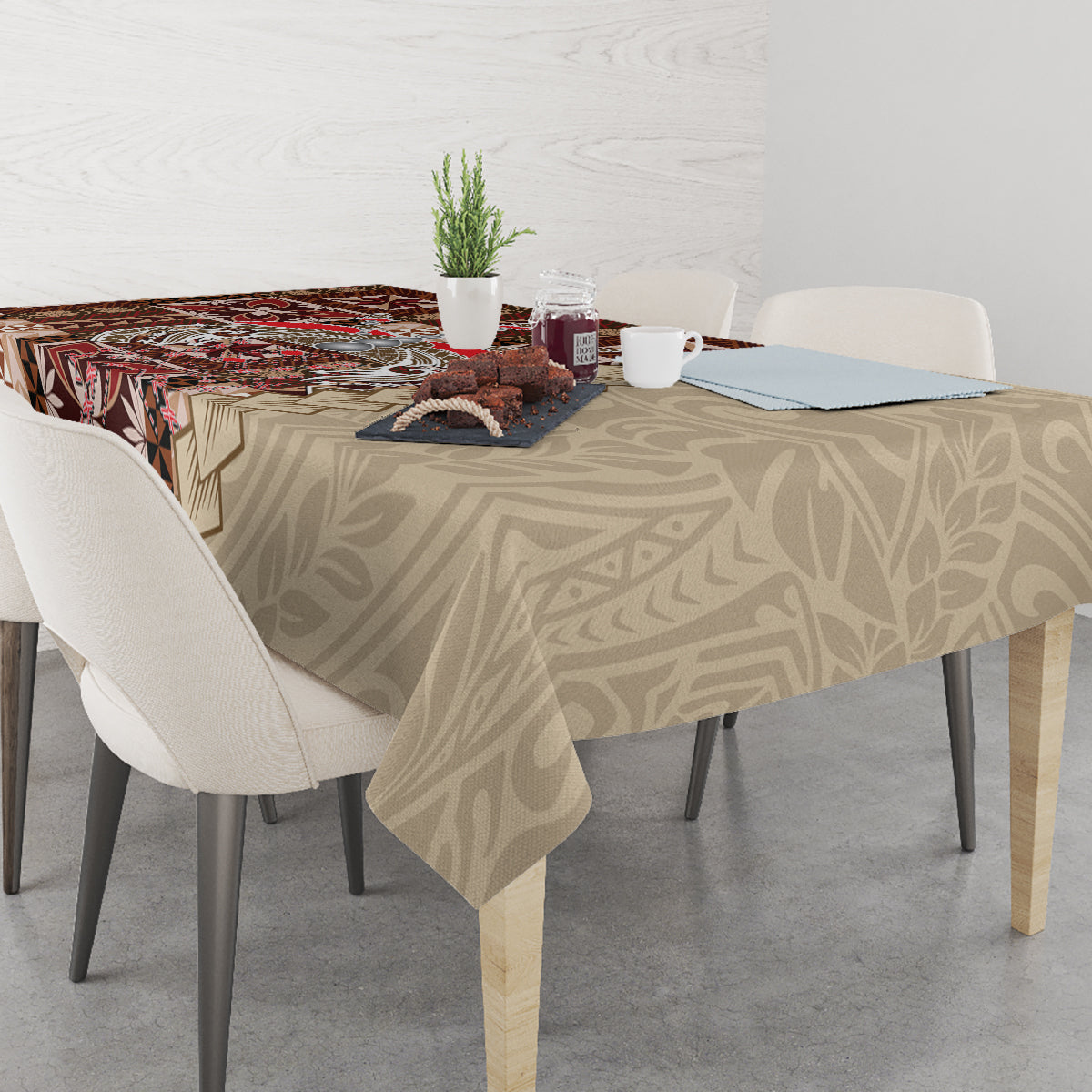 Brown patterned tablecloth with siapo-style motifs across a dining table, partially draped
