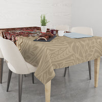 Brown patterned tablecloth with siapo-style motifs across a dining table, partially draped