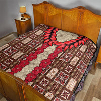Brown and cream quilt with red leaf wreath and red floral center, diamond-quilted texture