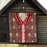 Brown quilt with red leaf wreath and red floral stripe over cream diamond-quilted pattern