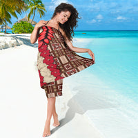Brown sarong with red flower vine and red leaf designs, framed by geometric tapa patterns