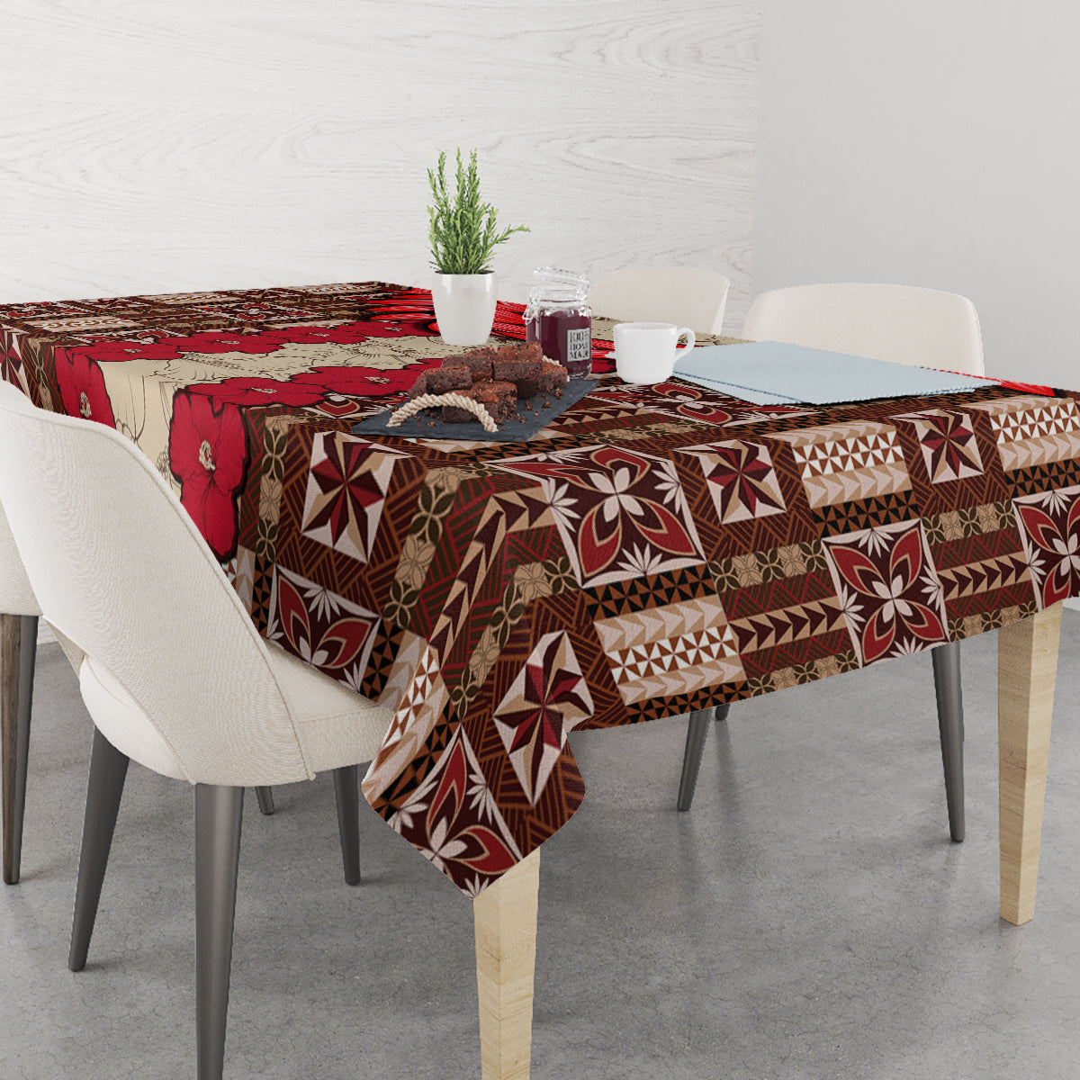 Rectangular tablecloth with red, brown, and cream tapa pattern draped on table