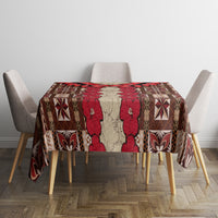 Tablecloth on square dining table with red tapa floral and geometric motifs