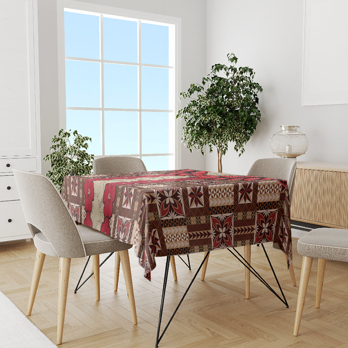 Brown tablecloth with red tapa pattern covering dining table between chairs