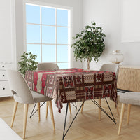 Brown tablecloth with red tapa pattern covering dining table between chairs