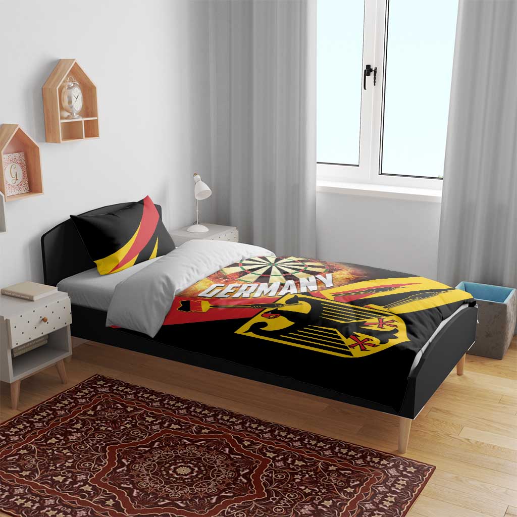 Black bedding set on bed with dartboard, flaming burst, shield, and red-yellow accents