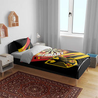 Black bedding set on bed with dartboard, flaming burst, shield, and red-yellow accents
