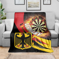 Darts blanket draped over sofa; flaming dartboard with red stripe, black and yellow print