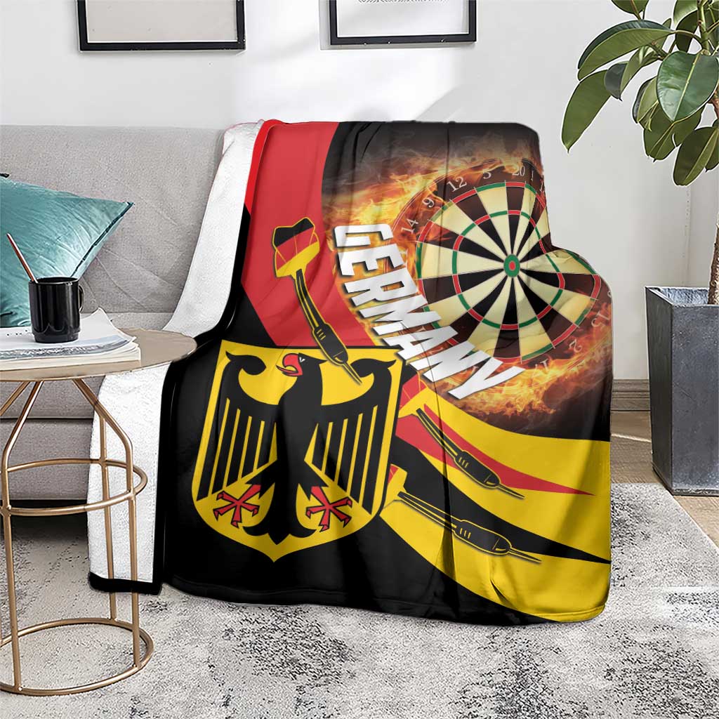 Darts blanket on floor beside plants; flaming dartboard on black with red stripe and yellow