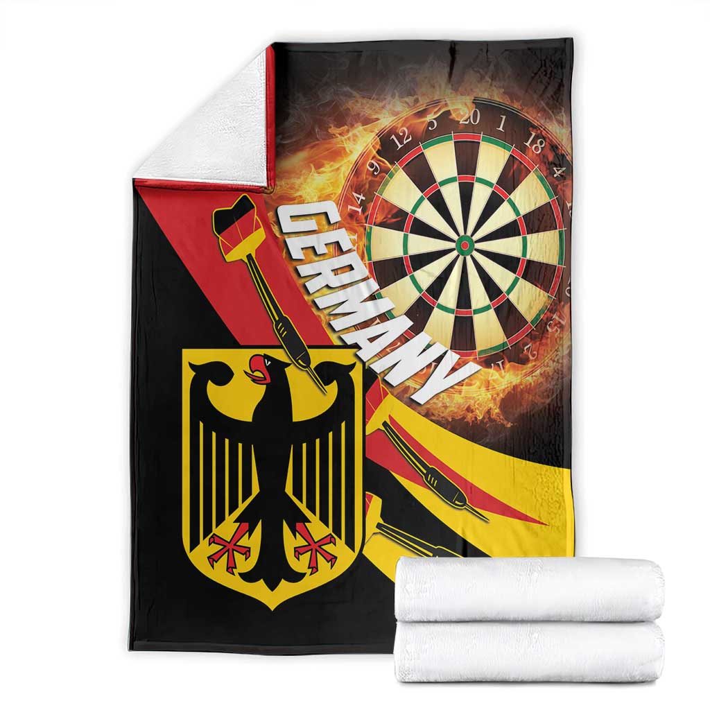 Darts blanket folded with white towels; flaming dartboard artwork on black with red panel
