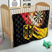 Germany-themed quilt on crib with black quilting, dartboard artwork, and red and yellow panels