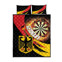 Dartboard-style quilt bed set with two black quilted pillows, red and yellow details