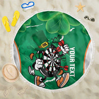 Green round darts beach blanket with fringed edge, showing dartboard mascot and shamrock leaves