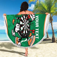 Green circular darts beach blanket with fringed edge, dartboard mascot design and “YOUR NEXT” text