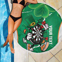 Green round darts beach blanket with fringed edge, dartboard mascot artwork and shamrock leaf pattern