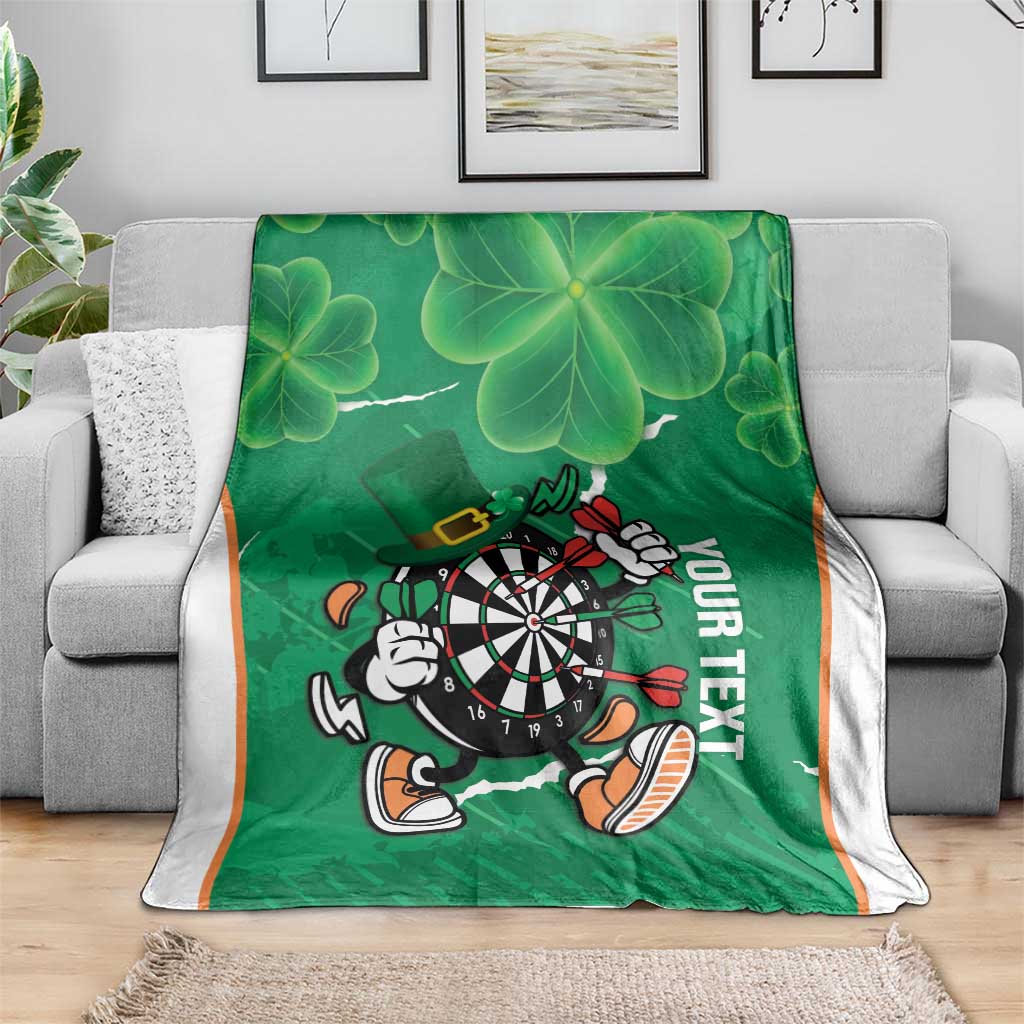Green clover-pattern darts blanket with dartboard mascot and 'YOUR TEXT' lettering, white trim
