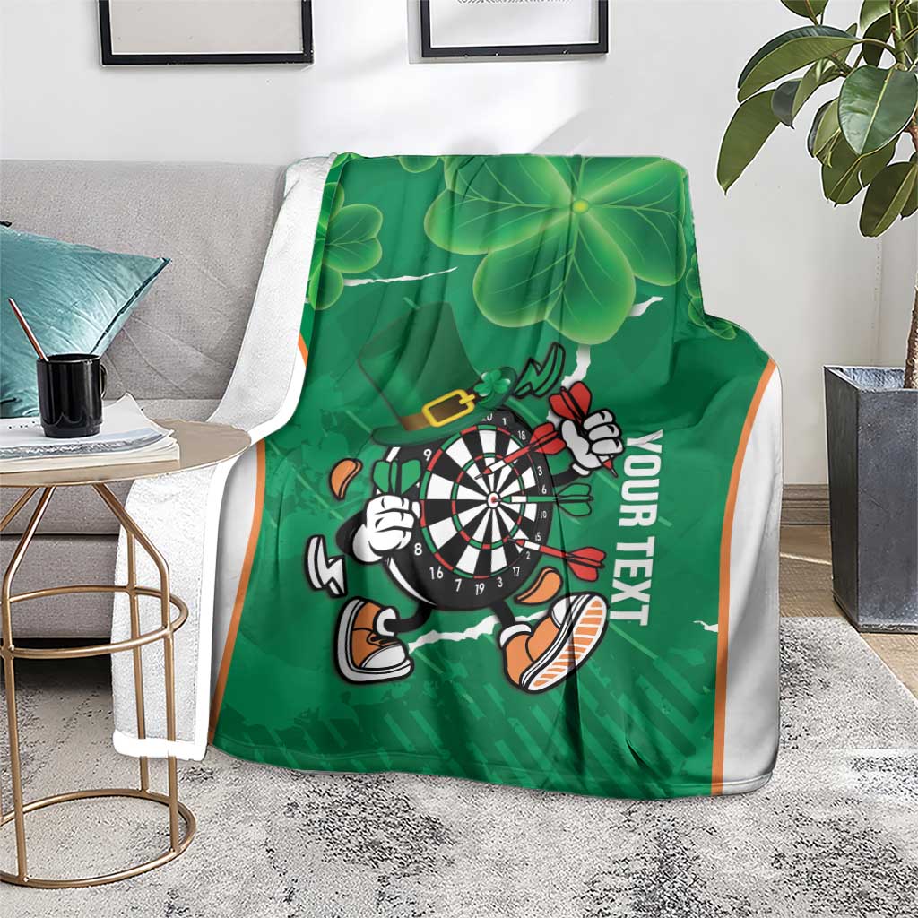 Green darts blanket with shamrock clover leaves and dartboard mascot, 'YOUR TEXT' text, white trim