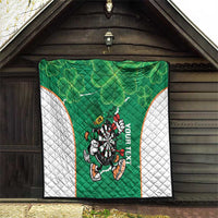 Green darts mascot quilt with white side panels and clover shamrock pattern inside a doorway