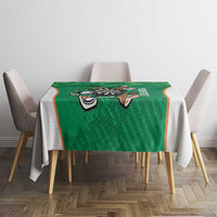 Green darts tablecloth with dartboard mascot print and shamrock accents