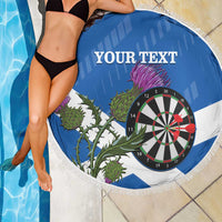 Round blue and white darts beach blanket with dartboard and thistle graphic, fringed border