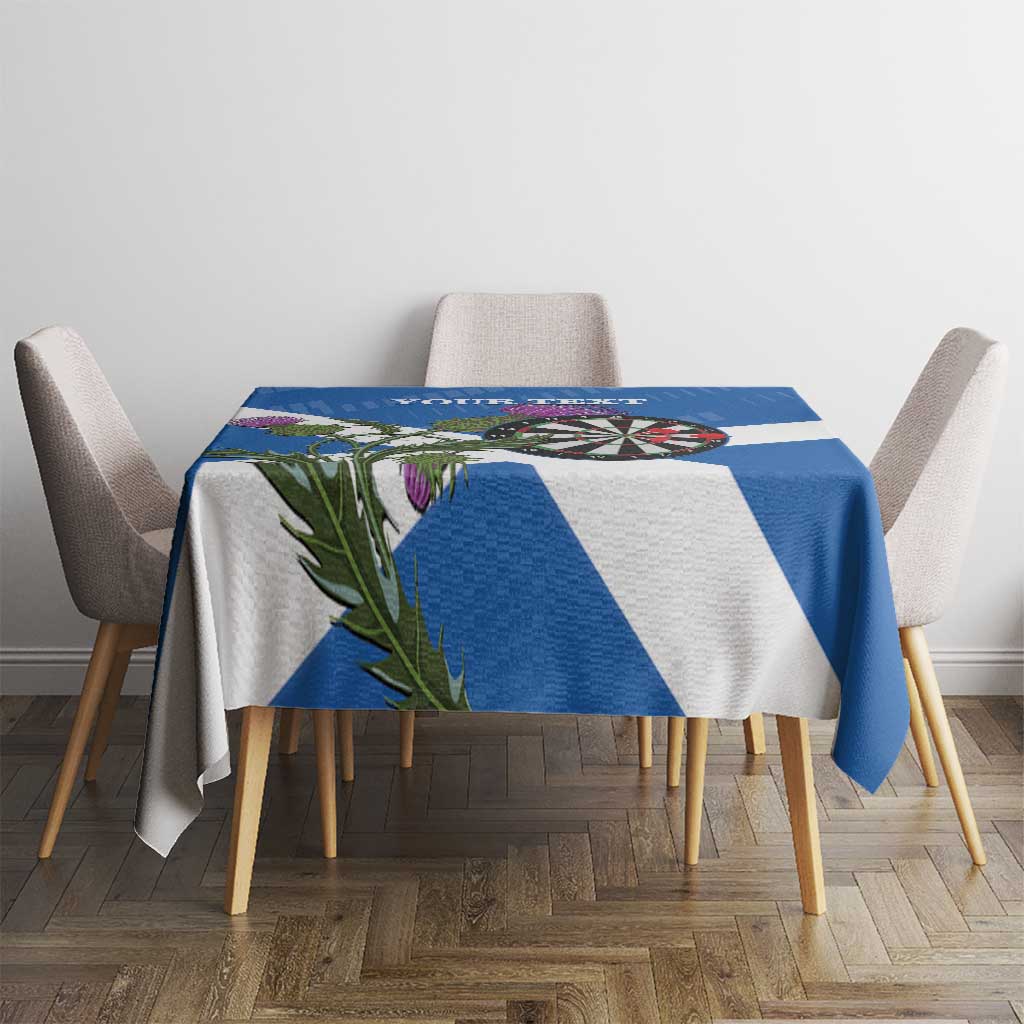 Blue and white Scotland darts tablecloth on table with dartboard, thistle leaves, and stripes