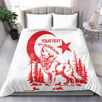 White duvet and pillows with red wolf, pine trees, and crescent-star artwork