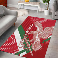 Red area rug with white eagle and sword motif and green-red stripe details