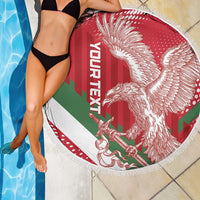 Round red Hungary football beach blanket with winged lion graphic and fringe border