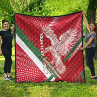 Red Hungary quilt draped outdoors, showing eagle graphic and green/white diagonal stripe
