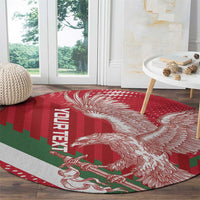Red round rug with white eagle illustration and green striped section