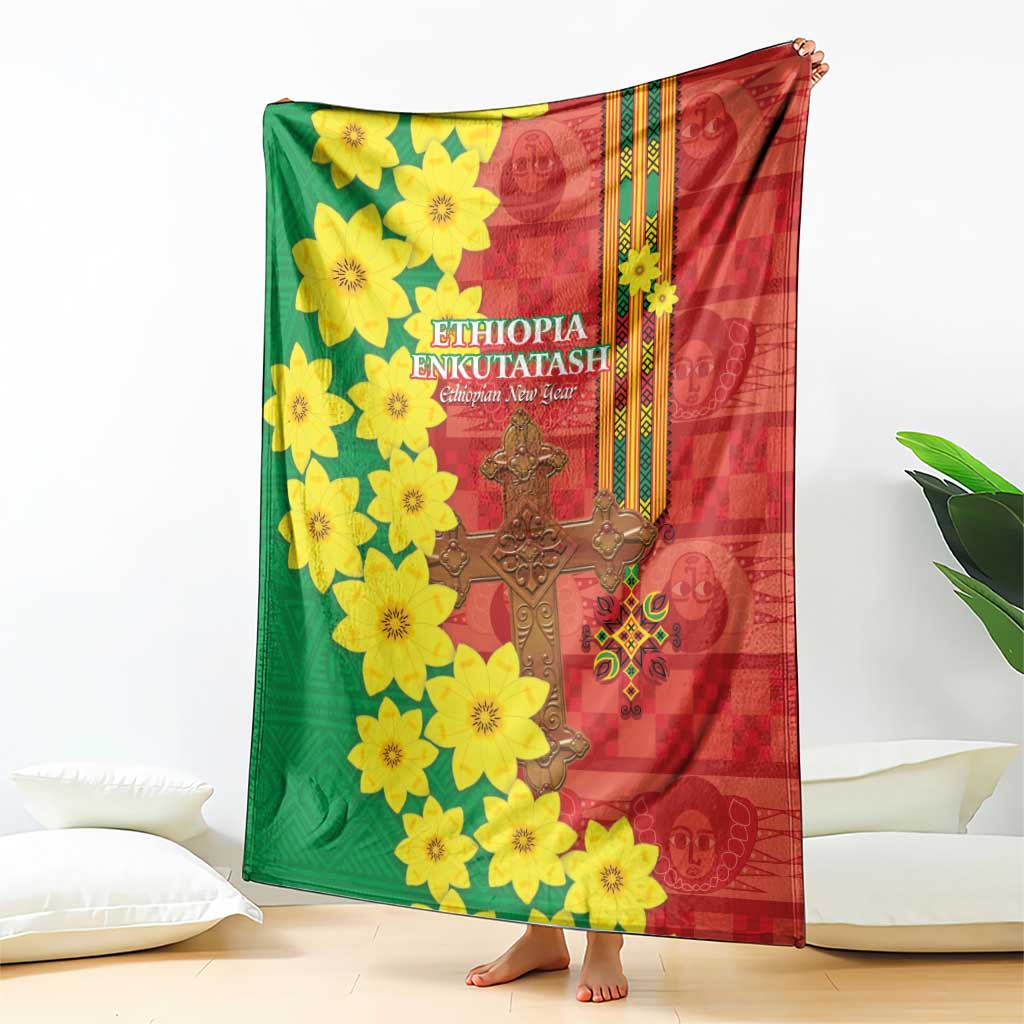 Red and green Ethiopian blanket with yellow flower cluster design and ornate gold cross