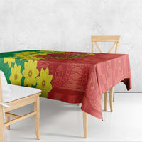 Red and green Ethiopia tablecloth with yellow flowers and decorative pattern edge on table