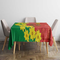 Red and green Ethiopia tablecloth with yellow flowers draped over dining table